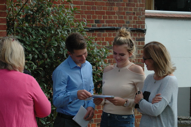Alton Convent School's Amber Jones delighting in her GCSE results with Head of Sixth Form, Mr Sanderson.