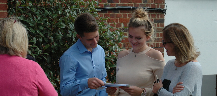 Alton Convent School's Amber Jones delighting in her GCSE results with Head of Sixth Form, Mr Sanderson.